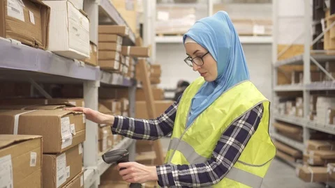 Muslim in hijab shop worker with barcode scanner Stock Footage 100767295