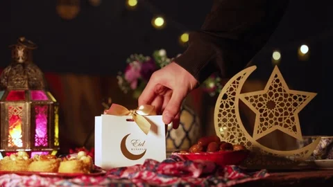 The Muslim Holiday of Eid. Gift boxes on the table with sweets for children and Stock Footage 312451371