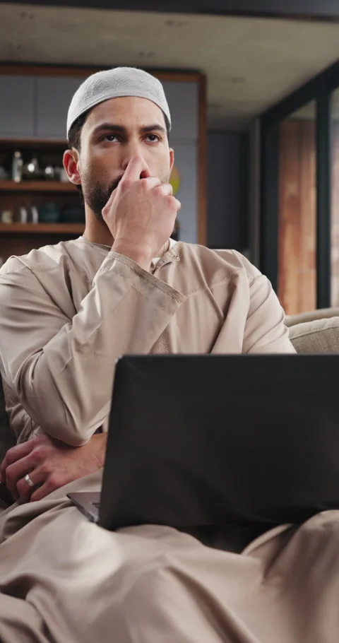 Muslim, man and remote work in house with laptop, thinking and typing news Stock Footage 329399717