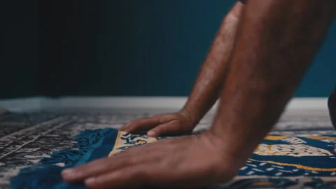 Muslim man bowing and getting up from a prayer rug Stock Footage 275307924