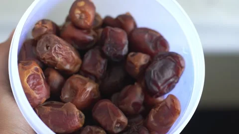 Muslim man eating date to break fast during ramadan iftar at home Stock Footage 328986793