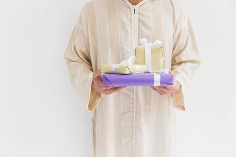 Muslim man holding present boxes Stock Photos