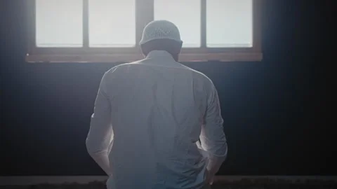 Muslim man praying in front of a window on his knees Stock Footage 275305361