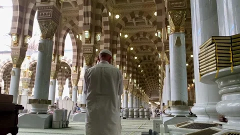 A Muslim man praying inside the Prophet's Mosque Stock Footage 332963460