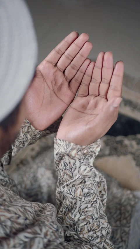 A muslim man is praying sincerely with his hands open in a tranquil environment Stock Footage 346513517