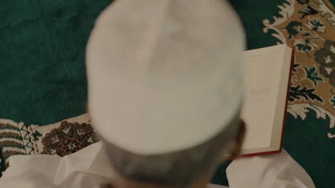 Muslim man reading from a book Stock Footage 279709700
