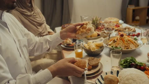 Muslim Man Sharing Pita Bread with Family Members During Festive Dinner Stock Footage 266311603