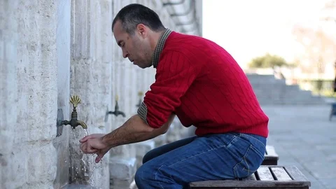 Muslim man taking ablution for prayer Stock Footage 104119946
