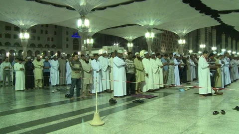 Muslim men bowing during prayer at the Prophet's Mosque in Medina Stock Footage 86759957