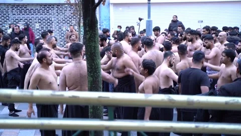 Muslim men chest beating at High street outside Redbridge Town Hall Ilford Essex Stock Footage 167504250