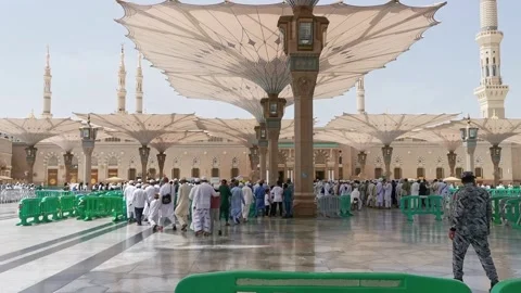 Muslim pilgrim men queue up to get into the entrance of Nabawi mosque Stock Footage 274472247