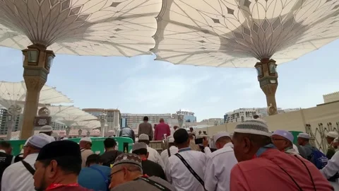 Muslim pilgrim men wait up outside to get into the entrance of Nabawi mosque Видео 274472166