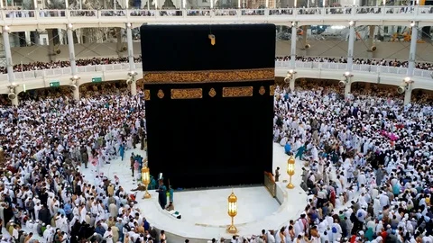 Muslim pilgrims get ready to perform evening prayer facing the Kaaba Stock Footage 96151680