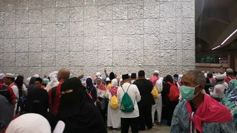 Muslim pilgrims performed a 'stoning of the devil' ritual at one of wall pillars Stock Footage 129736773
