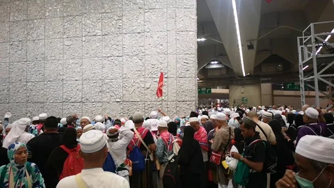 Muslim pilgrims performed a 'stoning of the devil' ritual at one of wall pillars Stock Footage 129736817