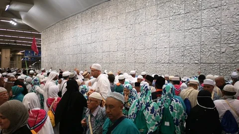 Muslim pilgrims performed a 'stoning of the devil' ritual at one of wall pillars Stock Footage 129736964
