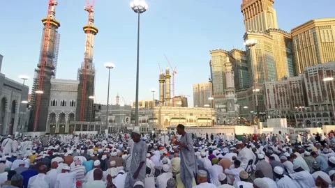 Muslim pilgrims wait for evening prayers outside Haram Mosque in Mecca Stock Footage 274472924