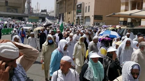 Muslim pilgrims walk back to their places after Friday prayers in Makkah Stock Footage 274472952