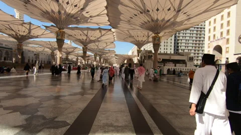 Muslim pilgrims walking in compound of Mosque Al Nawabi, Medina, Saudi Arabia Stock Footage 141854102