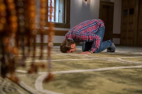 Muslim praying in a mosque Stock Photos