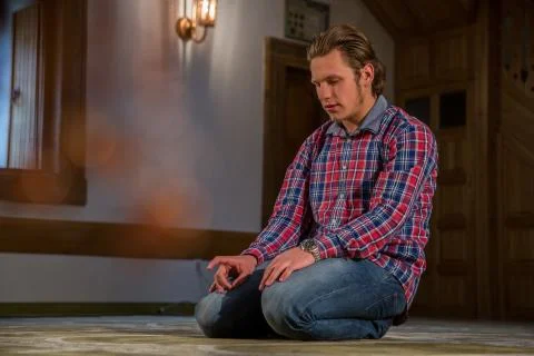 Muslim praying in a mosque Stock Photos