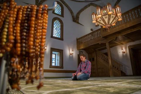 Muslim praying in a mosque Stock Photos