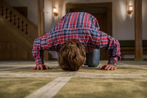 Muslim praying in a mosque Stock Photos