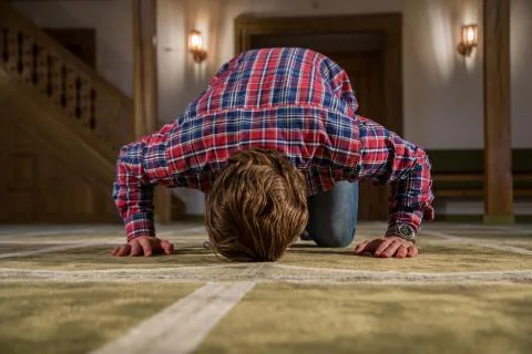 Muslim praying in a mosque Stock Photos