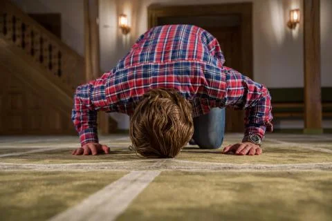 Muslim praying in a mosque Stock Photos