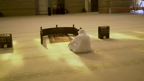 A Muslim prays while reading the Koran in the Al Fateh mosque, in Bahrain Stock Footage 244900182