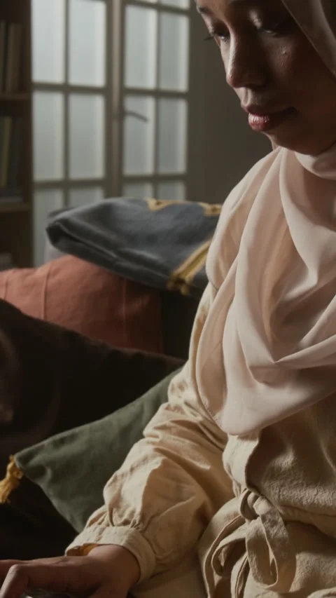 Muslim Woman in Hijab Using Computer While Sitting on Couch Vertical Stock Footage 331817189