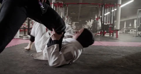 Muslim wrestler practicing escape technique with coach 스톡 동영상 232406049