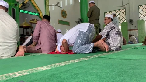 Muslims performing Friday prayers in a prostrate position Stock Footage 258904870