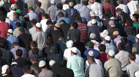 Muslims prayers on celebration of Eid al-Fitr (Uraza-Bairam). Crowd of migrants Stock Footage 64765768