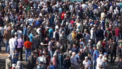 Muslims prayers on celebration of Eid al-Fitr (Uraza-Bairam). Crowd of migrants Stock Footage 72085279