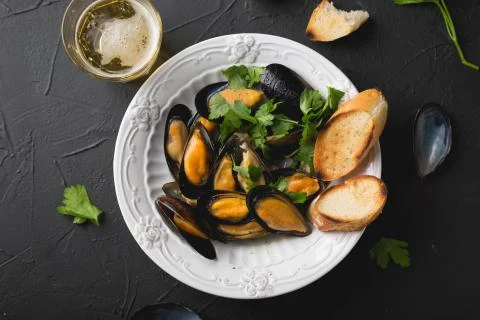 Mussels with parsley and crispy baguette Stock Photos