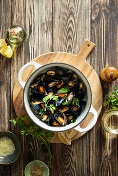 Mussels in a pot culinary concept, top down view Stock Photos