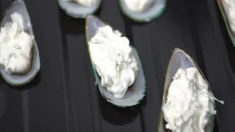 Mussels in a shell with cheese sause on baking sheet. Close-up. HD Stock Footage 141446373