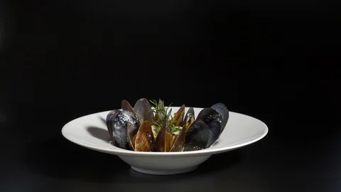 Mussels with a sprig of dill on white plate Stock Footage