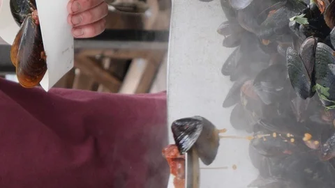 Mussels in their shells, seafood cooked in pan on fire, food prepared on street Stock Footage 126084348