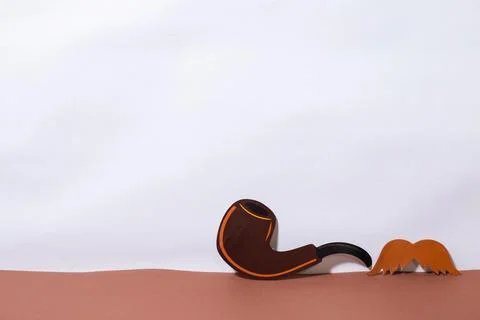 Mustache and pipe on a light background Stock Photos