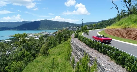 Mustang Convertible Drives Around Mountain Stock Footage