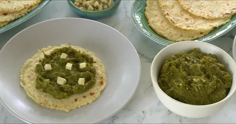 Mustard greens puree, cornmeal flatbreads, and chopped ginger. Stock Footage 329442687