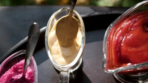 Mustard sauce isolated on background, rotating. stir in the cream and ketchup Stock Footage 319930623