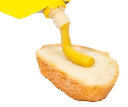 Mustard squeezed on bread Stock Photos
