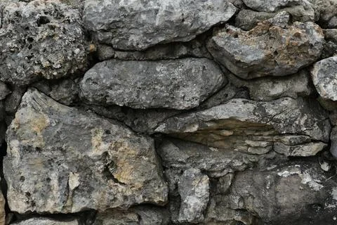 Muted Grey and Brown Rough Stone Wall Abstract Texture Background Weathered.. Stock Photos