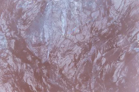 Muted mauve marble wave pattern showing delicate glitter veins and satin shee 스톡 사진