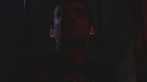 Mutilated and exhausted guy with all his might trying to get out of the locked Stock Footage 76603073