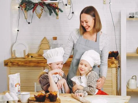 Mutter und Töchter backen Muffins zu Hause in der Küche Mother and daughte. Stock Photos