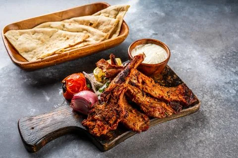 Mutton Champ or lamb chop bbq grill with pita bread, nan, tandoori roti, ra.. Stock Photos